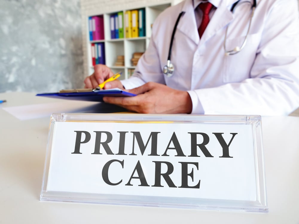 Primary care concept. The doctor writes down the medical history.